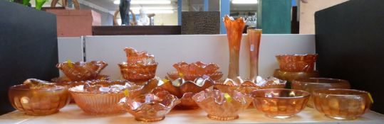 Twenty-six pieces of mainly orange Carnival glass including Good Luck,
