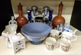 A pair of terracotta covered vases and underplates possibly Prattware,