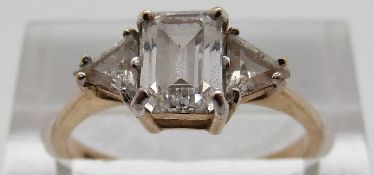 A 9ct gold ring set with an emerald cut cubic zirconia and two triangular cubic zirconia, size N, 2.