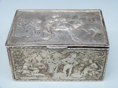 A continental white metal box with hinged lid decorated with 18thC style Watteau scenes in relief