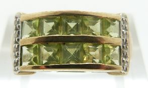 A 9ct gold ring set with square peridot and diamonds, size K, 3.