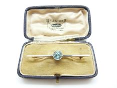 A 15ct gold brooch set with a zircon with a platinum finish