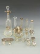 A large collection of hallmarked silver mounted glass items comprising cut glass decanter,