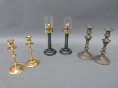 Three pairs of candlesticks comprising one brass,