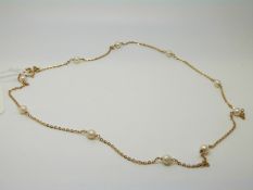 A yellow metal necklace marked 750,