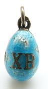 A Russian silver egg pendant set with aqua enamel, 'XB' to one side and a seed pearl to the other,