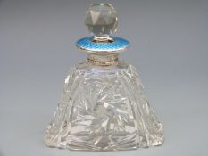A hallmarked silver and guilloché enamel cut glass scent / perfume bottle,