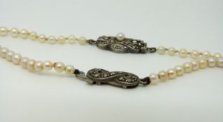 Two pearl necklaces with silver clasps