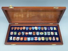 A cased set of 42 hallmarked silver and enamel Danbury Mint Heraldic Emblems of the Kings and