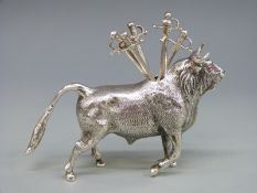 A continental white metal novelty cocktail stick holder in the form of a bull, length 10cm,
