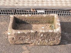 A small carved natural stone trough,