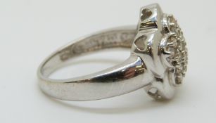 A 14ct white gold ring set with diamonds in a cluster,