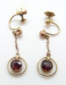 A pair of 9ct gold earrings set with garnets