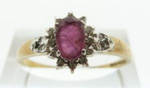 A 9ct gold ring set with a ruby and diamonds, size T, 1.
