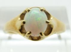 A yellow metal ring set with an oval opal cabochon, size P, 4.