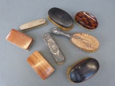 A collection of dressing table brushes one silver topped
