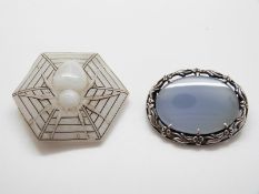 An Arts & Crafts silver mounted chalcedony brooch and Art Deco hexagonal glass spider brooch