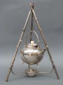 A plated spirit kettle with unusual three-branch tripod stand