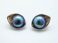 A pair of 18ct white gold earrings set with a pearl and three diamonds to each, 9.