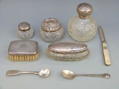 A collection of hallmarked silver mounted cut glass bottles,