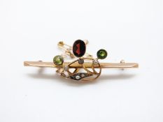 A 9ct gold brooch set with seed pearls, peridot and an oval garnet, 2.