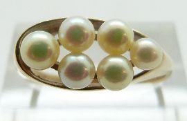 A 9ct gold ring set with pearls, size R, 3.