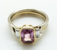 A bi-coloured 18ct gold ring set with an emerald cut pink sapphire and two baguette cut diamonds,