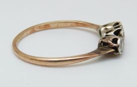 A 9ct gold ring set with three diamonds in a platinum setting (size P)