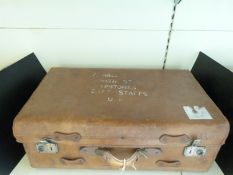 A vintage brown leather suitcase,