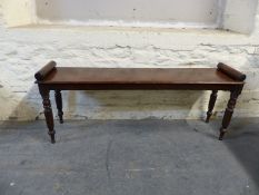 A 19thC mahogany window seat with octagonal legs,