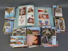 An album of postcards including Donald McGill and other humorous examples and a quantity of loose