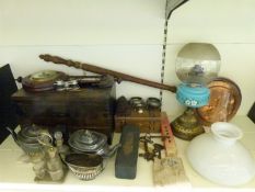 A wooden chest containing a selection of vintage tools together with an aneroid barometer, oil lamp,
