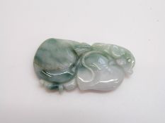 A carved jadeite pendant in the form of two peaches and a jadeite beaded bracelet
