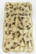 A 19thC Chinese Canton ivory card case carved all over with floral decoration,