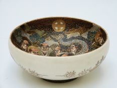 A 19thC Japanese Satsuma bowl depicting figures, dragon and a scroll with mark to base,