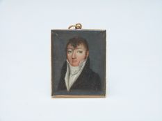A small French portrait miniature of a gentleman in yellow metal frame,