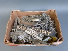 A large quantity of mainly 1960's, 70's and 30's car badges including VW, Mercury, Perkins, Bedford,