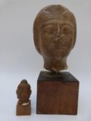 An Oriental carved stone head on wooden base, 27cm,