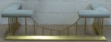 An upholstered brass club fender,