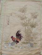 A late 19thC Japanese embroidery on silk of a cockerel, hens and chicks beneath a bamboo thicket,
