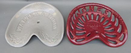 Two cast iron tractor or implement seats, one Walter A.