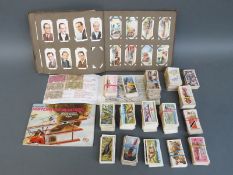 A collection of c1930's - 1960's cigarette and tea cards, some in albums and some loose,
