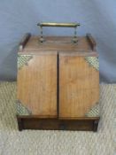 A late 19th /20thC wooden coal scuttle with patent lever action handle opening the twin doors