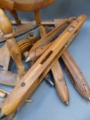 A small wooden spinning wheel with shuttles