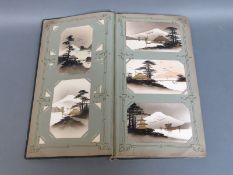 An Edwardian era postcard album with approximately 115 Japanese cards including a good percentage