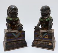 A pair of Chinese silver models in the form of Dogs of Fo, set with enamel and engraved detail,