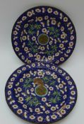 A pair of 19thC Chinese enamel on copper plates decorated with prunus blossom and bamboo on blue