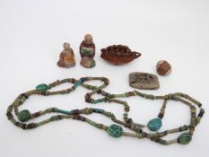 A 19thC Chinese carved nut in the form of a Chinese boat,