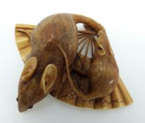 A Japanese Meiji period netsuke in the form of two rats on an open fan, signed to base,