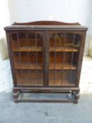 An oak glazed display cabinet,